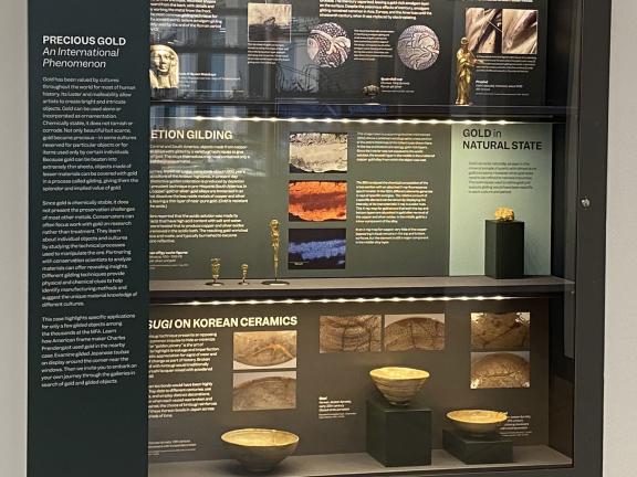 A display case showing examples of different gilding techniques